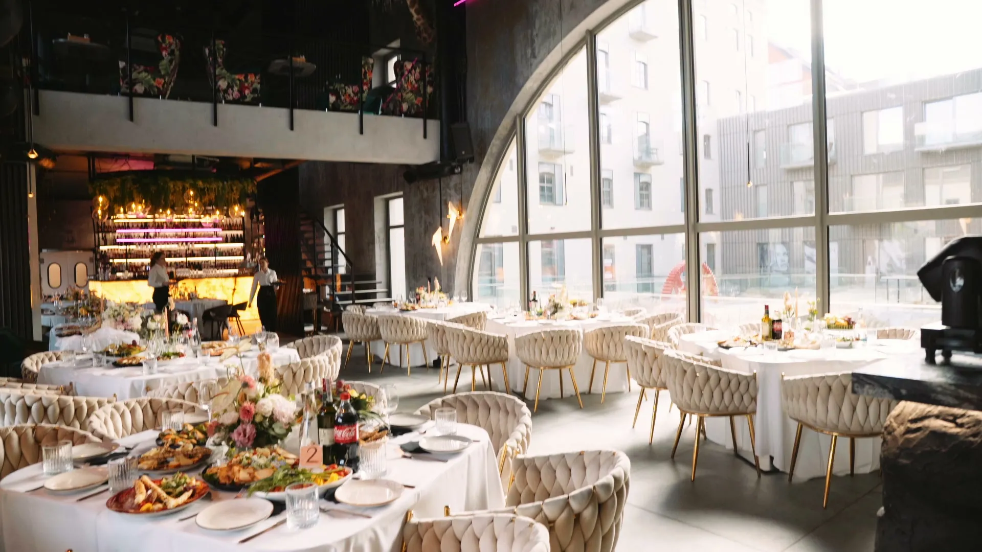 Selection hall set for a corporate evening — dressed tables, mezzanine and terrace in a historic mill in Wrocław